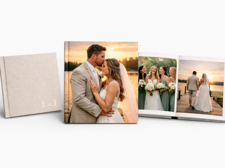 A wedding photo book featuring a couple by a lake at sunset and bridal party images.