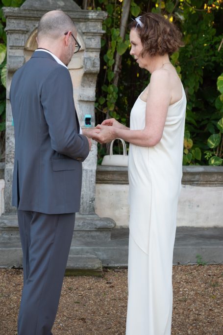 A couple exchanging vows during an outdoor wedding ceremony.
